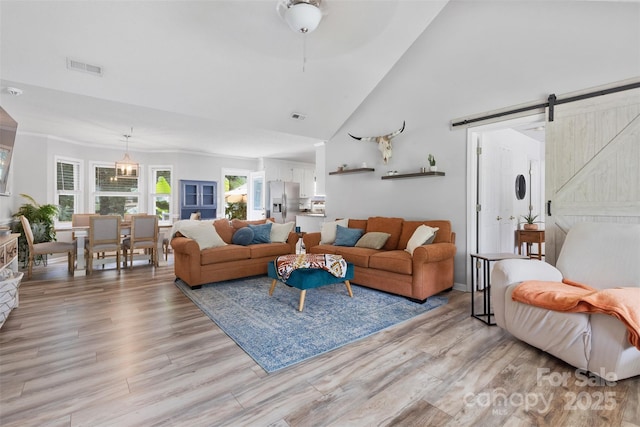 1507 Breckenwood Dr, Rock Hill, SC 29732 - living room with a barn door, light wood-type flooring, and high vaulted ceiling