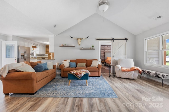 1507 Breckenwood Dr, Rock Hill, SC 29732 - living area featuring a barn door, light wood finished floors, a ceiling fan, and high vaulted ceiling
