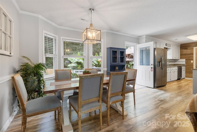 1507 Breckenwood Dr, Rock Hill, SC 29732 - dining space featuring plenty of natural light, a chandelier, a textured ceiling, ornamental molding, and light wood-style floors