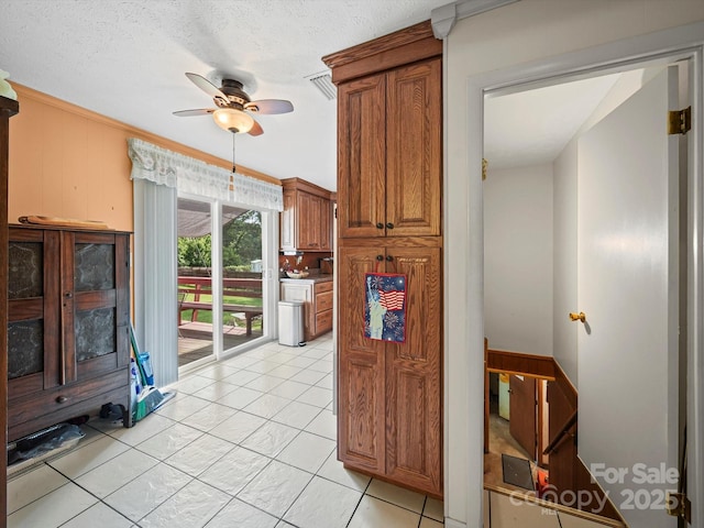 3471 Greentree Acres Rd, Valdese, NC 28690 - kitchen with ceiling fan, brown cabinetry, and light tile patterned floors