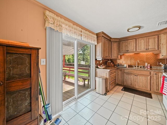 3471 Greentree Acres Rd, Valdese, NC 28690 - kitchen with tasteful backsplash, light tile patterned floors, and brown cabinets
