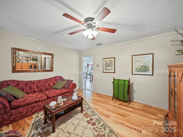 3471 Greentree Acres Rd, Valdese, NC 28690 - living area featuring wood finished floors, a ceiling fan, and a textured ceiling