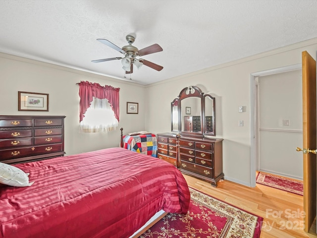 3471 Greentree Acres Rd, Valdese, NC 28690 - bedroom featuring light wood-type flooring, a ceiling fan, ornamental molding, and a textured ceiling