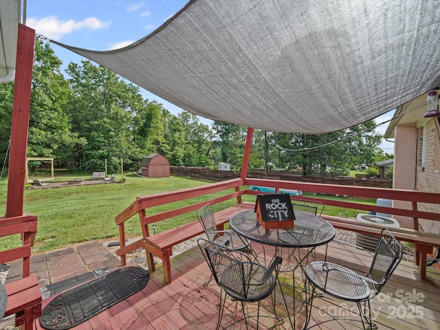 3471 Greentree Acres Rd, Valdese, NC 28690 - fenced backyard featuring a shed, a deck, view of wooded area, and outdoor dining space
