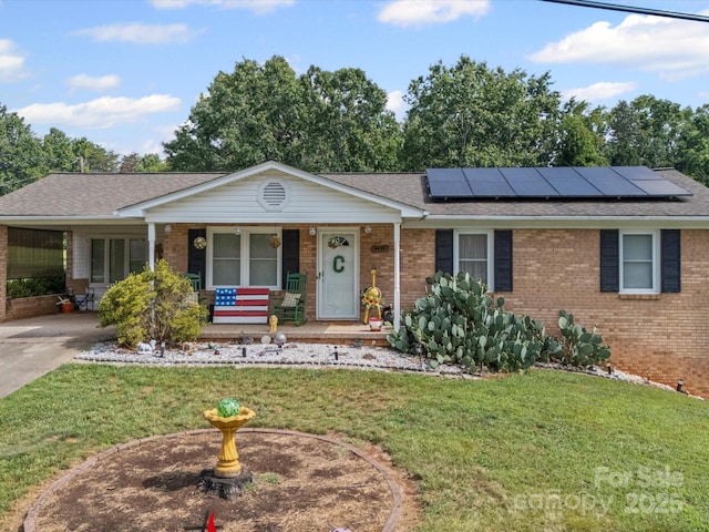 3471 Greentree Acres Rd, Valdese, NC 28690 - ranch-style house featuring brick siding, a porch, a front yard, a shingled roof, and solar panels