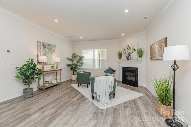 1514 Starmount Cove Ln, Charlotte, NC 28210 - living area with crown molding, a glass covered fireplace, light wood finished floors, and recessed lighting