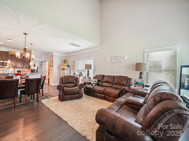 9428 Carneros Creek Rd, Charlotte, NC 28214 - living area featuring a chandelier, dark wood-style floors, and crown molding