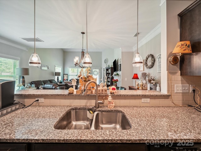 9428 Carneros Creek Rd, Charlotte, NC 28214 - kitchen featuring open floor plan, tasteful backsplash, crown molding, light stone countertops, and pendant lighting