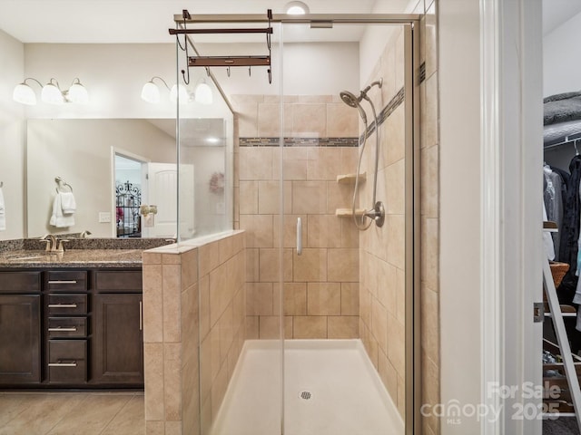 9428 Carneros Creek Rd, Charlotte, NC 28214 - full bathroom with a shower stall, vanity, tile patterned floors, and a spacious closet