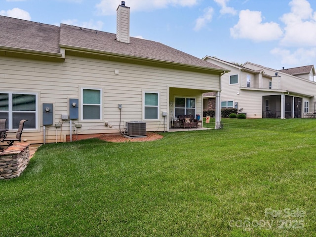 9428 Carneros Creek Rd, Charlotte, NC 28214 - rear view of property with a chimney, a yard, a patio, and a sunroom