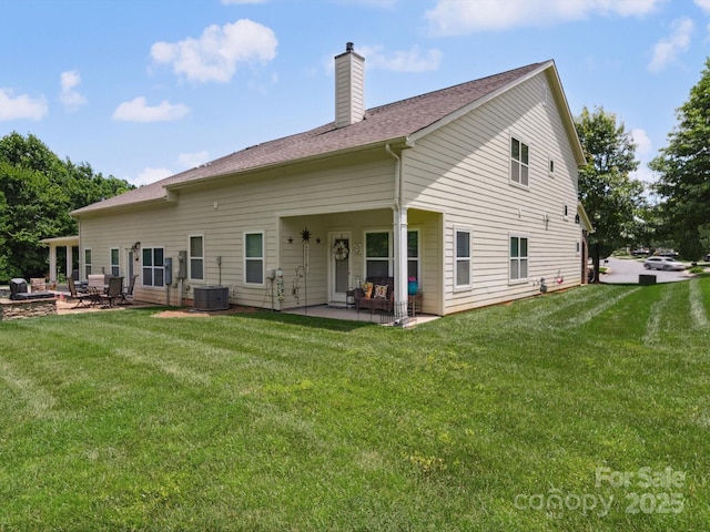 9428 Carneros Creek Rd, Charlotte, NC 28214 - rear view of house featuring a patio, a chimney, a yard, and a shingled roof