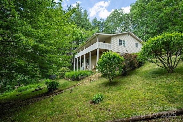 665 Will Robbins Ln, Newland, NC 28657 - view of side of home with a lawn and a deck