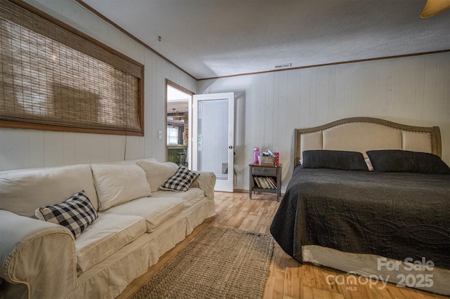 665 Will Robbins Ln, Newland, NC 28657 - bedroom with ornamental molding, wood finished floors, and wood walls