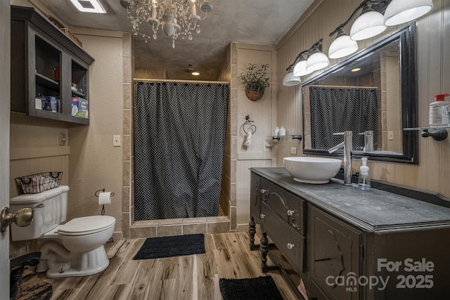 665 Will Robbins Ln, Newland, NC 28657 - bathroom with wood finished floors, a stall shower, vanity, and a chandelier