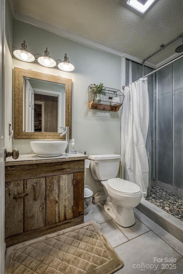 665 Will Robbins Ln, Newland, NC 28657 - bathroom with a stall shower, vanity, and a textured ceiling