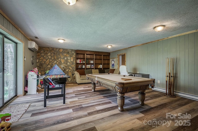665 Will Robbins Ln, Newland, NC 28657 - game room featuring a wall mounted air conditioner, a textured ceiling, wood finished floors, pool table, and ornamental molding