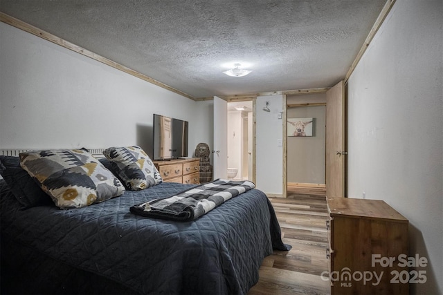 665 Will Robbins Ln, Newland, NC 28657 - bedroom featuring wood finished floors and a textured ceiling