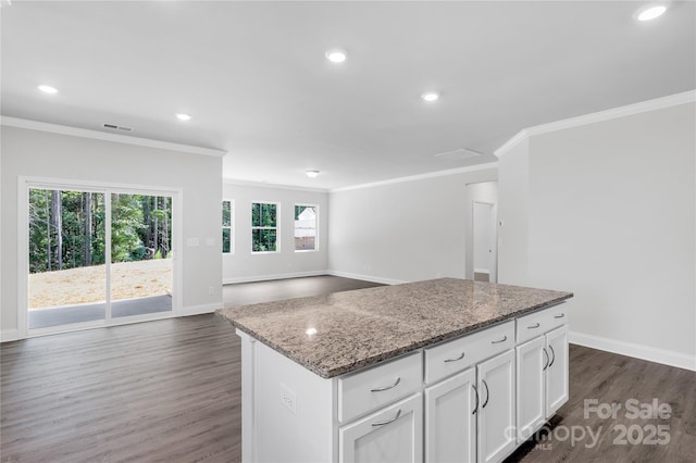 5244 Admirals Lndg, Lancaster, SC 29720 - kitchen featuring ornamental molding, a kitchen island, dark wood-style floors, light stone countertops, and white cabinets