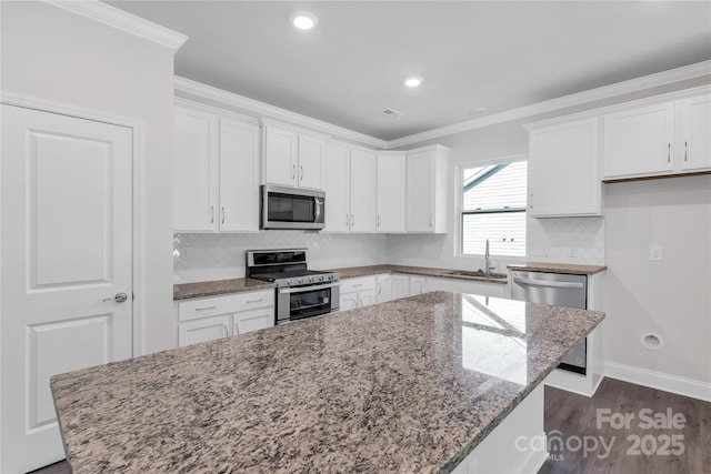 5244 Admirals Lndg, Lancaster, SC 29720 - kitchen with appliances with stainless steel finishes, white cabinetry, stone counters, a center island, and tasteful backsplash