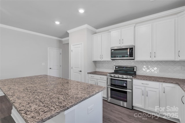 5244 Admirals Lndg, Lancaster, SC 29720 - kitchen featuring stainless steel appliances, crown molding, light stone countertops, dark wood-style floors, and white cabinetry