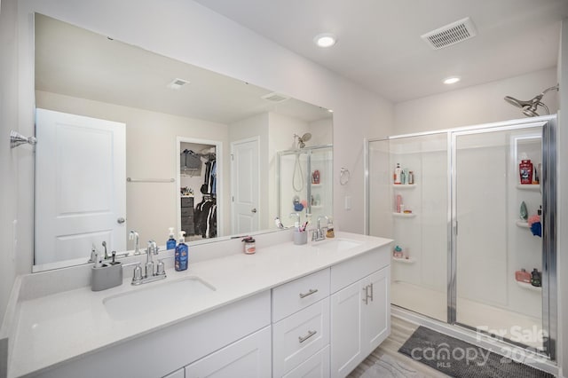 1010 Harry Ct, Albemarle, NC 28001 - full bath featuring double vanity, a shower stall, a walk in closet, and recessed lighting