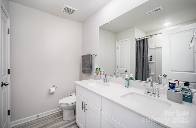 1010 Harry Ct, Albemarle, NC 28001 - full bathroom featuring double vanity, wood finished floors, and a shower with shower curtain