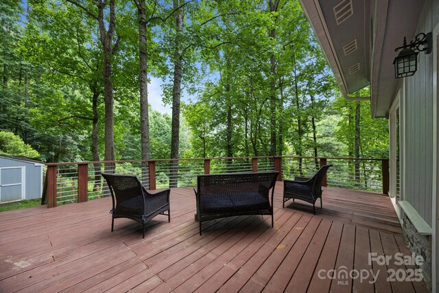 193 Timberside Dr, Mars Hill, NC 28754 - deck featuring a storage shed, view of scattered trees, and an outdoor hangout area