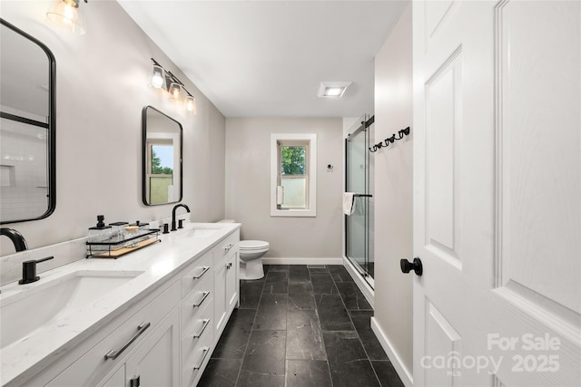 204 Terrys Gap Loop Rd, Fletcher, NC 28732 - bathroom featuring double vanity, a shower with shower door, and stone finish floors
