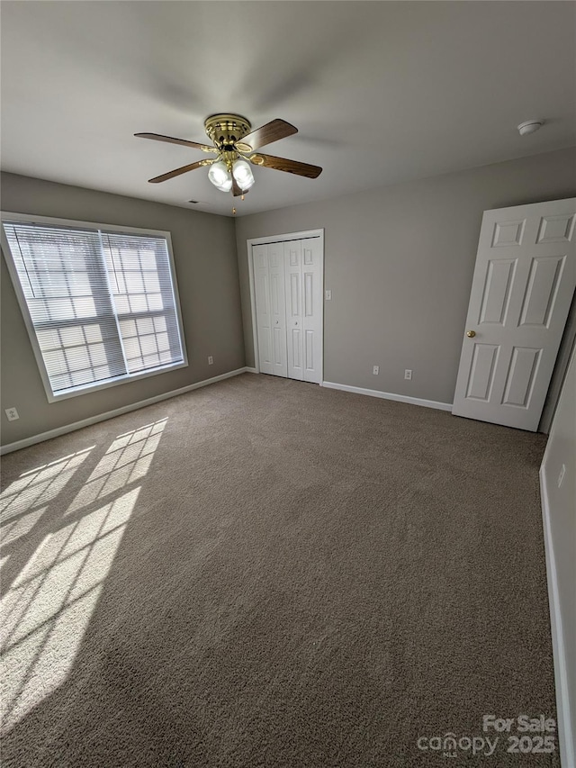 1009 22nd St NE Unit A-E, Hickory, NC 28601 - unfurnished bedroom with a closet, dark colored carpet, and ceiling fan