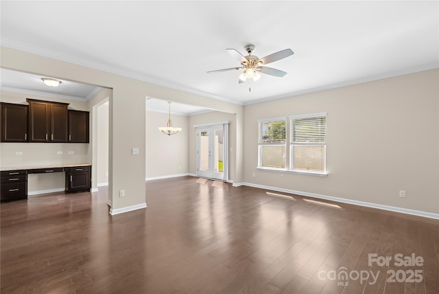 921 Summerlake Dr, Fort Mill, SC 29715 - unfurnished living room featuring a ceiling fan, dark wood-type flooring, crown molding, and a chandelier