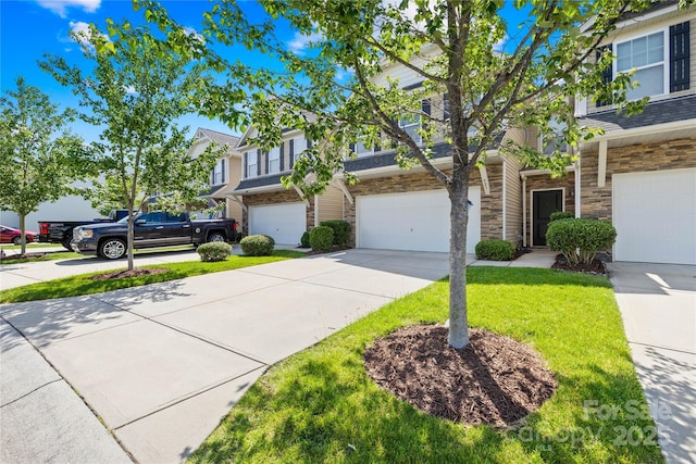 921 Summerlake Dr, Fort Mill, SC 29715 - view of front of house featuring an attached garage, stone siding, concrete driveway, and a front lawn