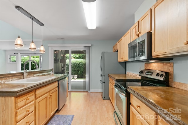 38 Live View Ln, Clyde, NC 28721 - kitchen featuring appliances with stainless steel finishes, light brown cabinets, light wood-type flooring, hanging light fixtures, and dark countertops