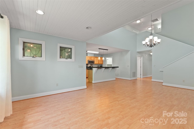 38 Live View Ln, Clyde, NC 28721 - unfurnished living room featuring a chandelier, light wood-style floors, wood ceiling, high vaulted ceiling, and recessed lighting