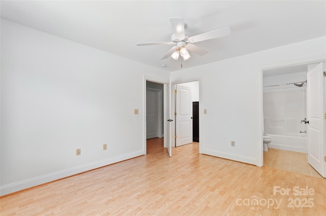 38 Live View Ln, Clyde, NC 28721 - unfurnished bedroom with light wood finished floors, connected bathroom, and ceiling fan