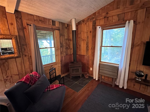 849 Camp Hill Rd, Mill Spring, NC 28756 - living area with wood walls, lofted ceiling, dark wood-type flooring, and a wood stove