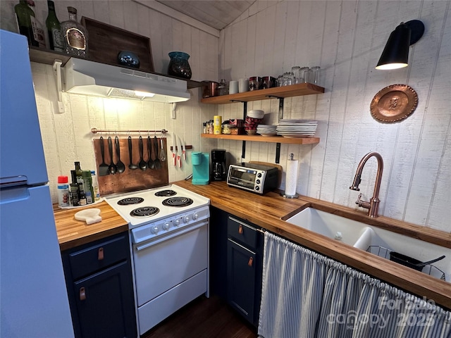 849 Camp Hill Rd, Mill Spring, NC 28756 - kitchen with wood counters, under cabinet range hood, white electric range oven, freestanding refrigerator, and vaulted ceiling