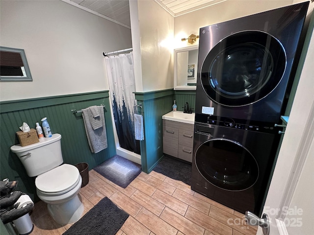 849 Camp Hill Rd, Mill Spring, NC 28756 - full bathroom featuring stacked washer / drying machine, wainscoting, a shower with curtain, ornamental molding, and vanity
