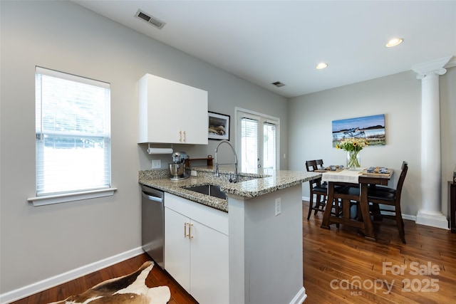 432 W Worthington Ave, Charlotte, NC 28203 - kitchen featuring stainless steel dishwasher, a peninsula, white cabinetry, dark wood-style floors, and light stone countertops