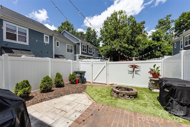 432 W Worthington Ave, Charlotte, NC 28203 - fenced backyard featuring a fire pit, a patio area, a gate, and a grill