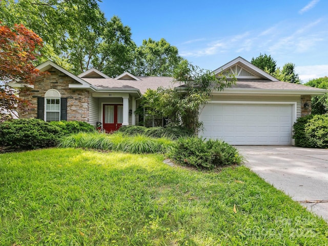 91 Talon Trail Ln, Etowah, NC 28729 - ranch-style home with an attached garage, driveway, stone siding, and a front lawn