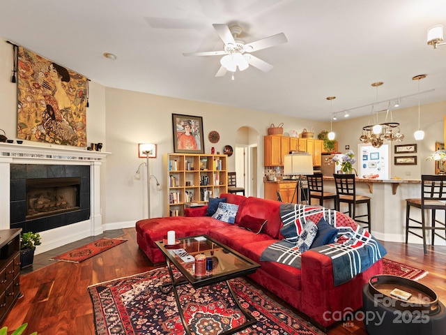 91 Talon Trail Ln, Etowah, NC 28729 - living area with dark wood finished floors, ceiling fan, arched walkways, and a tile fireplace
