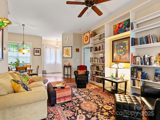 91 Talon Trail Ln, Etowah, NC 28729 - living area with a ceiling fan, healthy amount of natural light, wood finished floors, and built in shelves