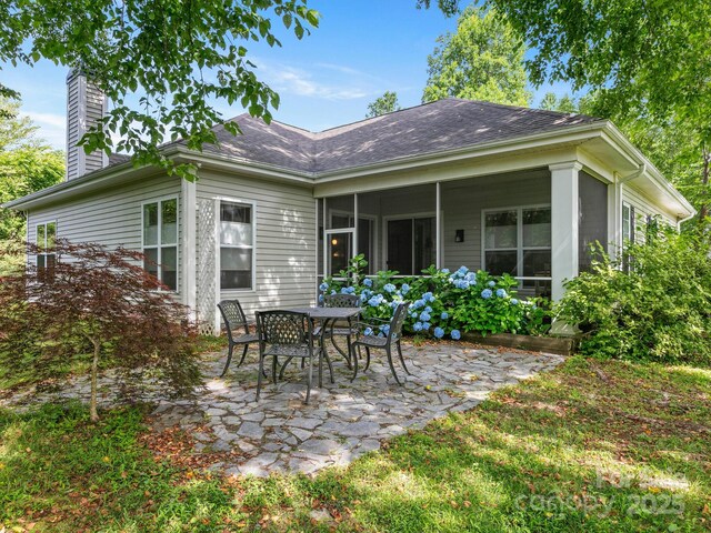 91 Talon Trail Ln, Etowah, NC 28729 - rear view of house with a patio, a chimney, a sunroom, and a shingled roof