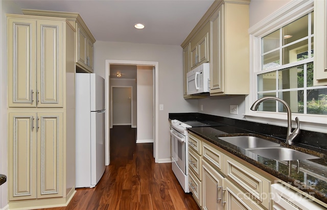 2706 Bremer Ct, Charlotte, NC 28210 - kitchen with white appliances, cream cabinetry, dark stone counters, and dark wood-style floors