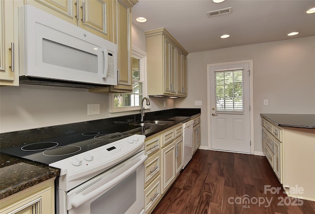 2706 Bremer Ct, Charlotte, NC 28210 - kitchen featuring white appliances, cream cabinets, dark wood-style floors, dark stone counters, and recessed lighting