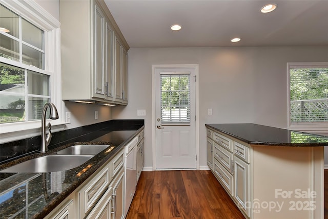 2706 Bremer Ct, Charlotte, NC 28210 - kitchen featuring dark wood-type flooring, recessed lighting, dark stone countertops, a peninsula, and dishwashing machine