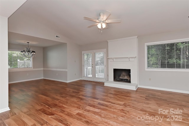 2706 Bremer Ct, Charlotte, NC 28210 - unfurnished living room featuring a chandelier, a ceiling fan, wood finished floors, a fireplace, and vaulted ceiling