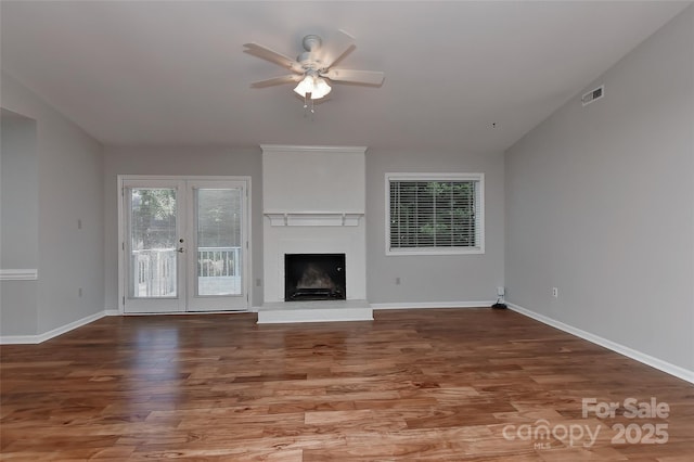 2706 Bremer Ct, Charlotte, NC 28210 - unfurnished living room featuring a ceiling fan, wood finished floors, lofted ceiling, a fireplace with raised hearth, and french doors