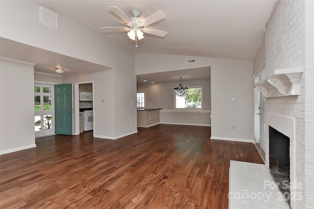 2706 Bremer Ct, Charlotte, NC 28210 - unfurnished living room with a brick fireplace, ceiling fan, wood finished floors, lofted ceiling, and a chandelier