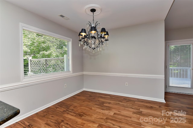 2706 Bremer Ct, Charlotte, NC 28210 - unfurnished dining area featuring a chandelier and wood finished floors